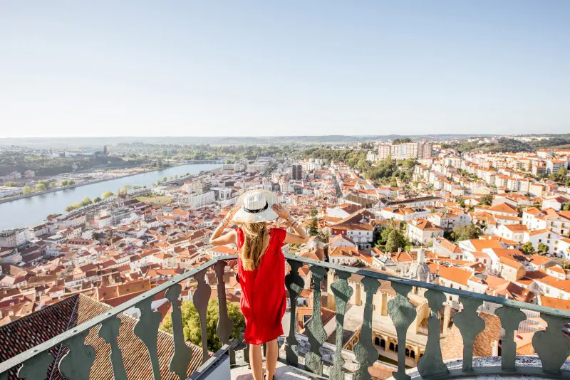 young-woman-enjoying-aerial-view-old-town-coimbra-city-sunset-central-portugal-woman-traveling-10356